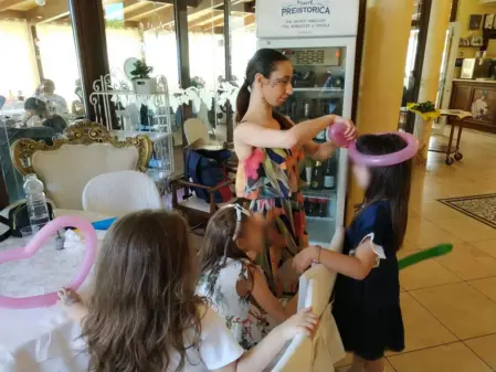 Animatore che realizza sculture di palloncini per bambini durante una festa di compleanno