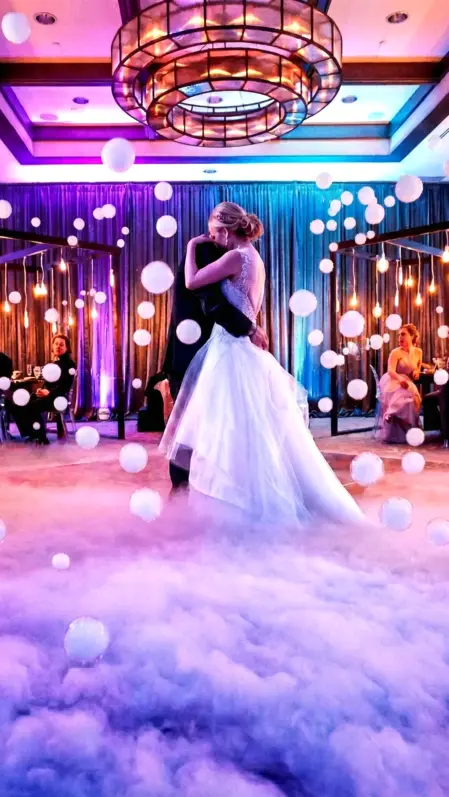 Bolle di sapone bianche nel ballo sulle nuvole durante un matrimonio bellissimo